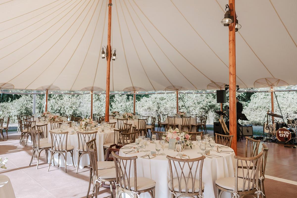 A wedding reception setting in a marquee