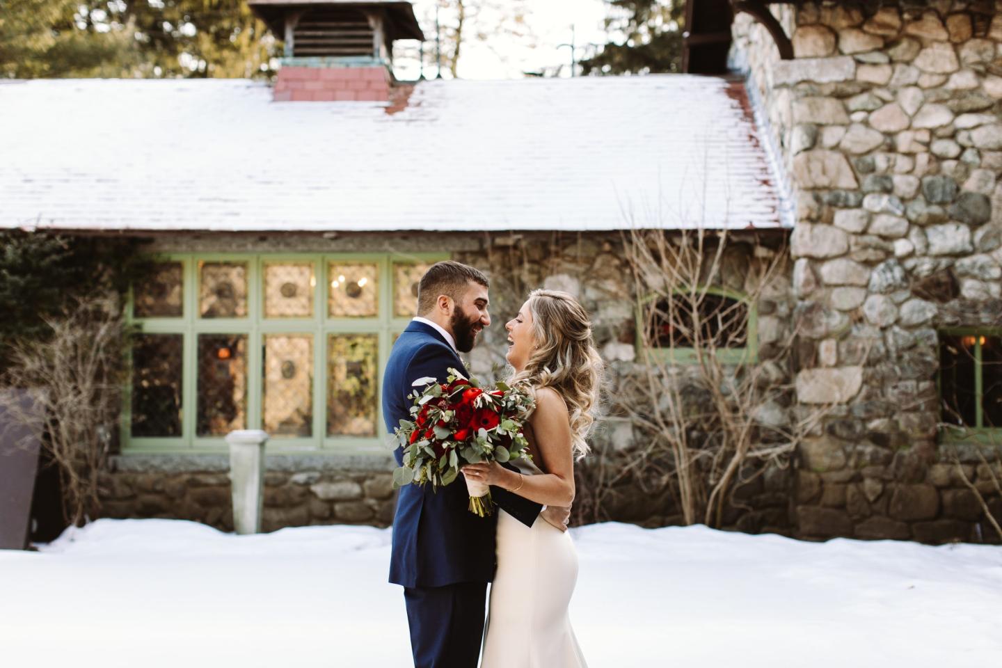 A bride and groom outside a mansion