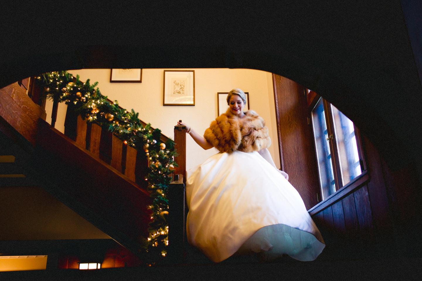 A bride walking down a set of stairs