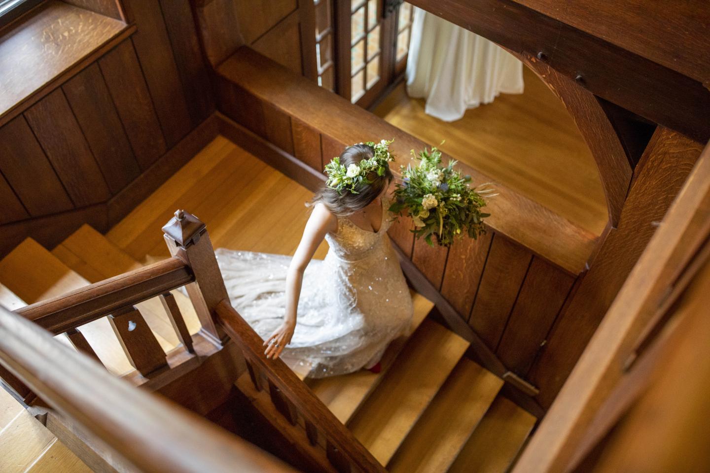 A bride walking down a set of stairs