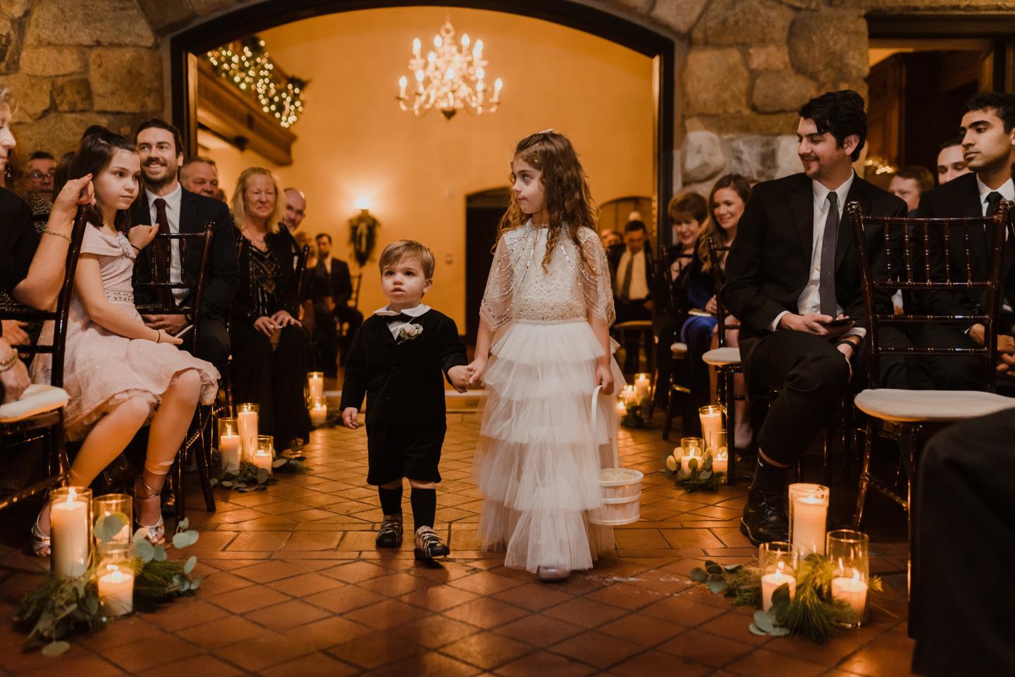 Two children walking down an aisle