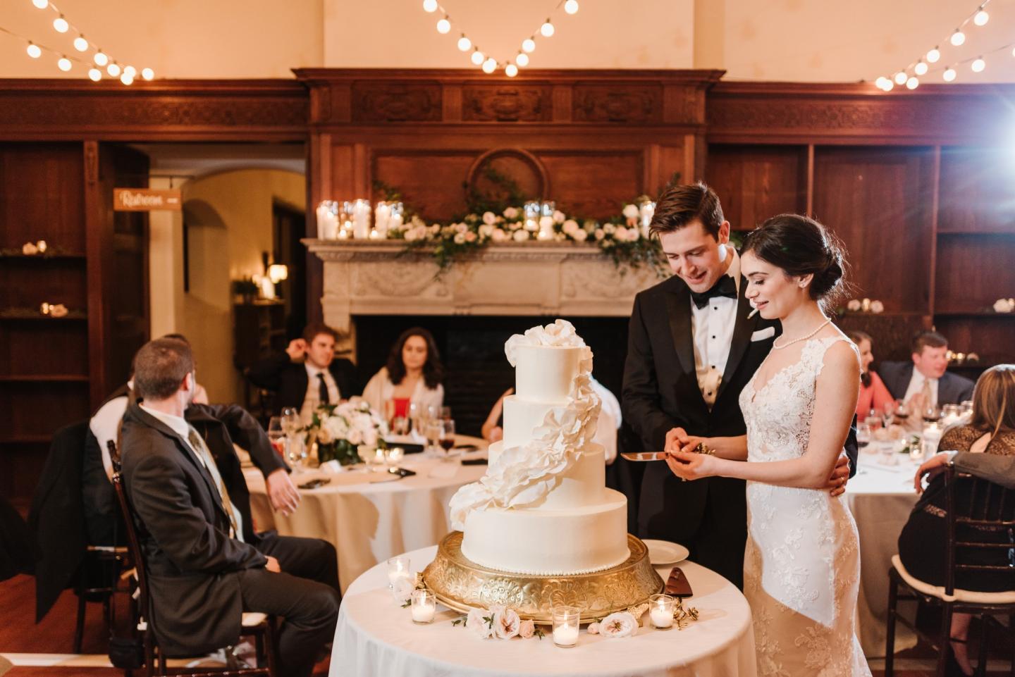 A bride and groom cutting a cake