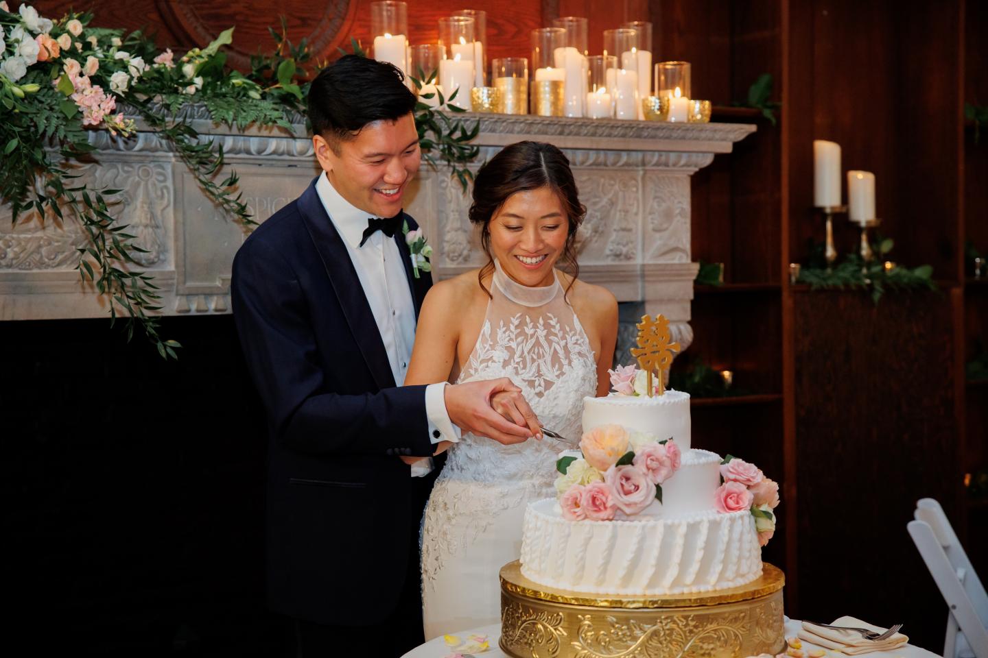 A bride and groom cutting a cake