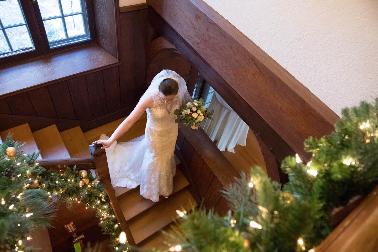A bride walking down a set of stairs