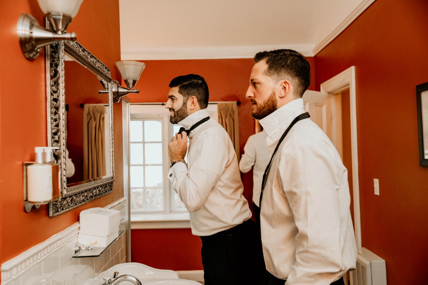 Two groomsmen getting ready