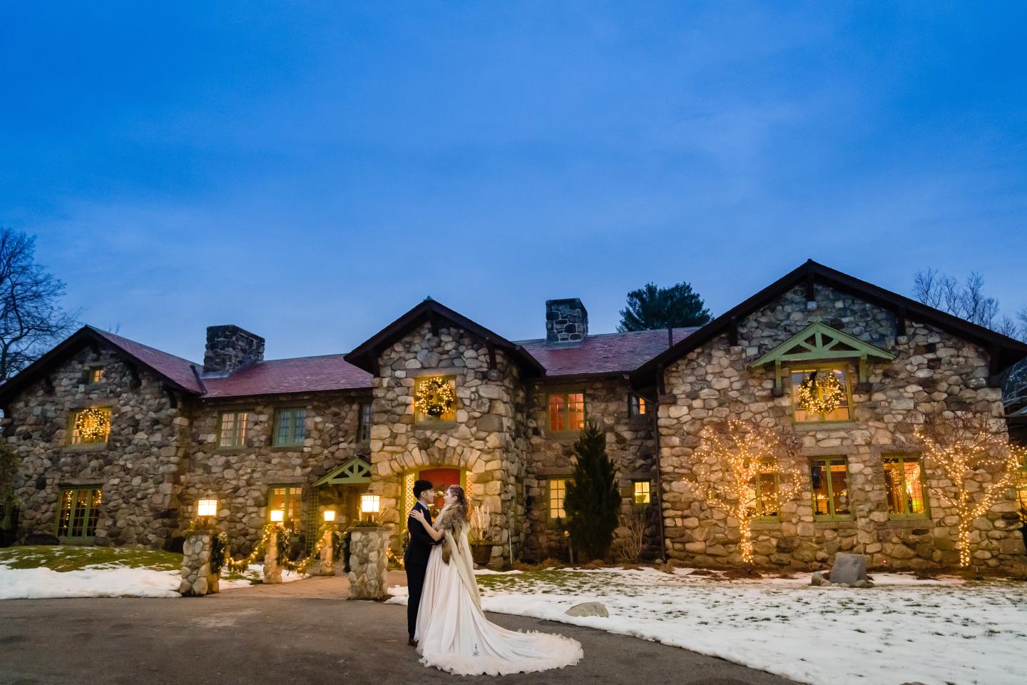 A bride and groom outside a mansion