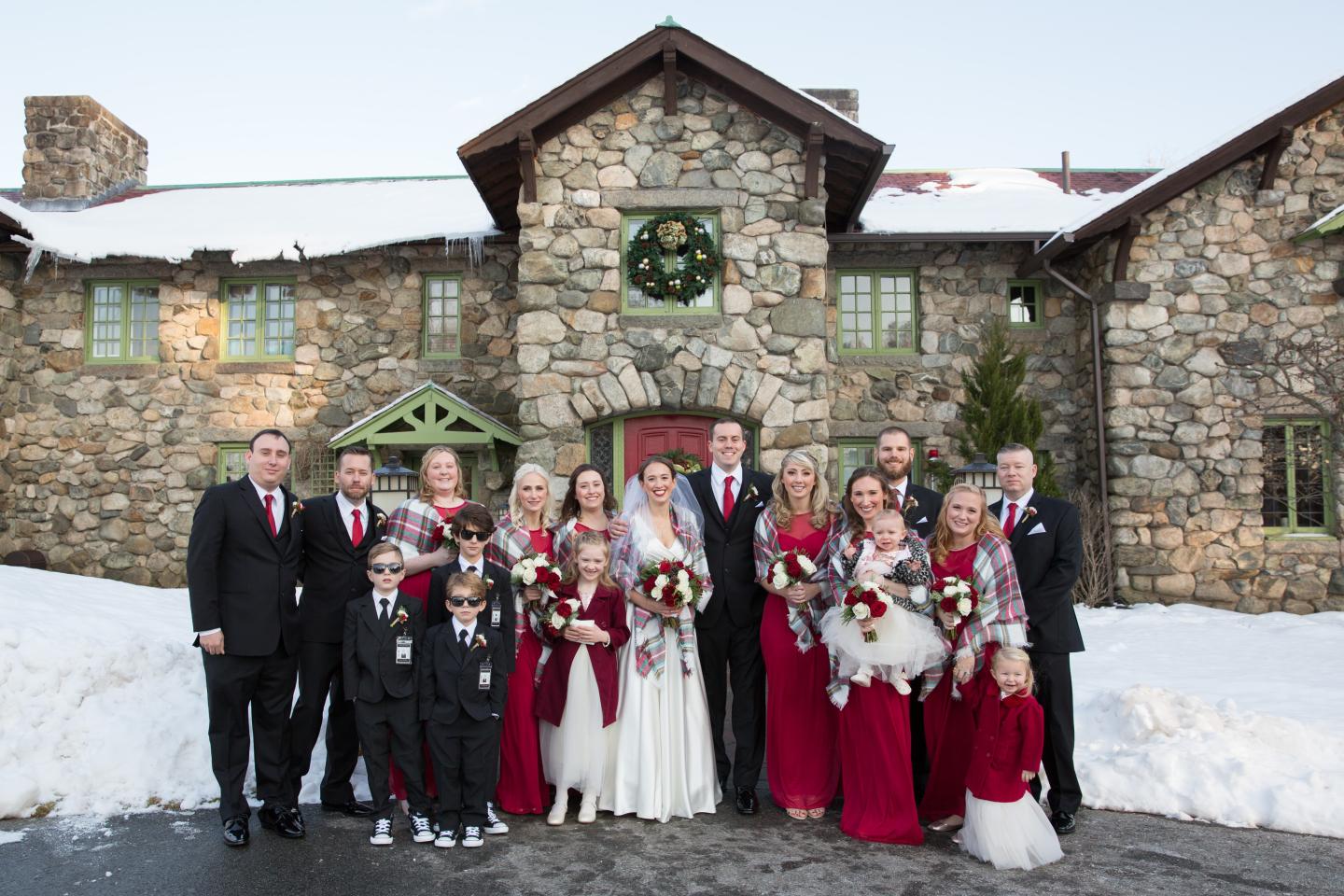 A wedding party outside a mansion