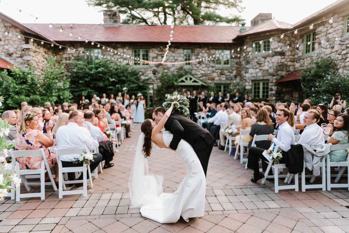 A bride and groom kiss at a wedding ceremony