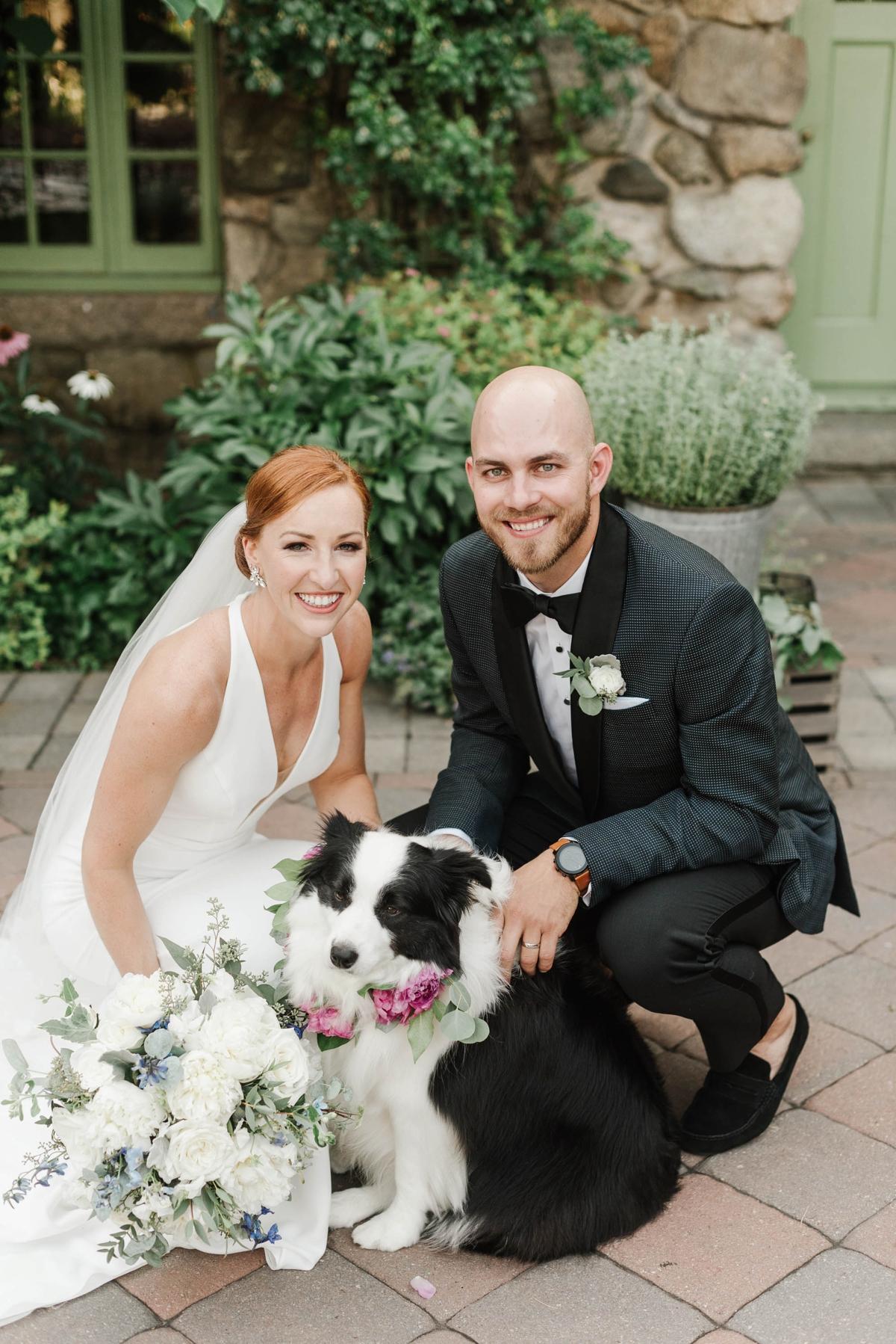 A bride and groom with their dog