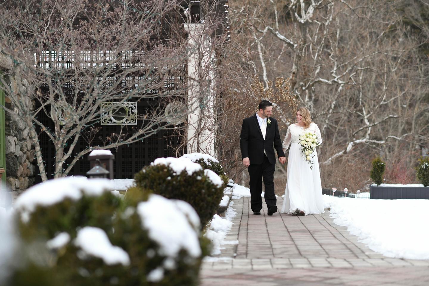 A bride and groom outside in winter