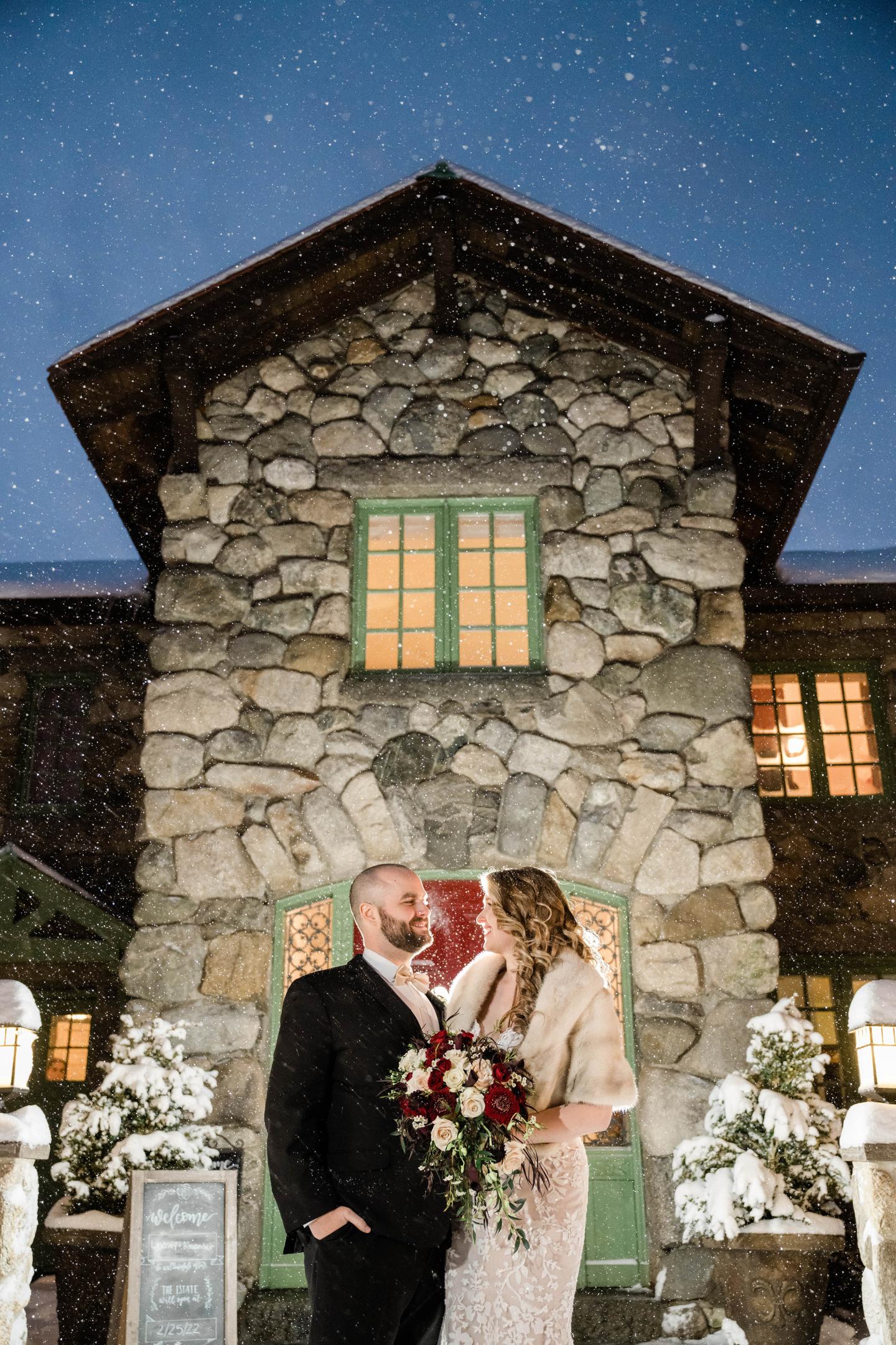 A bride and groom outside a mansion