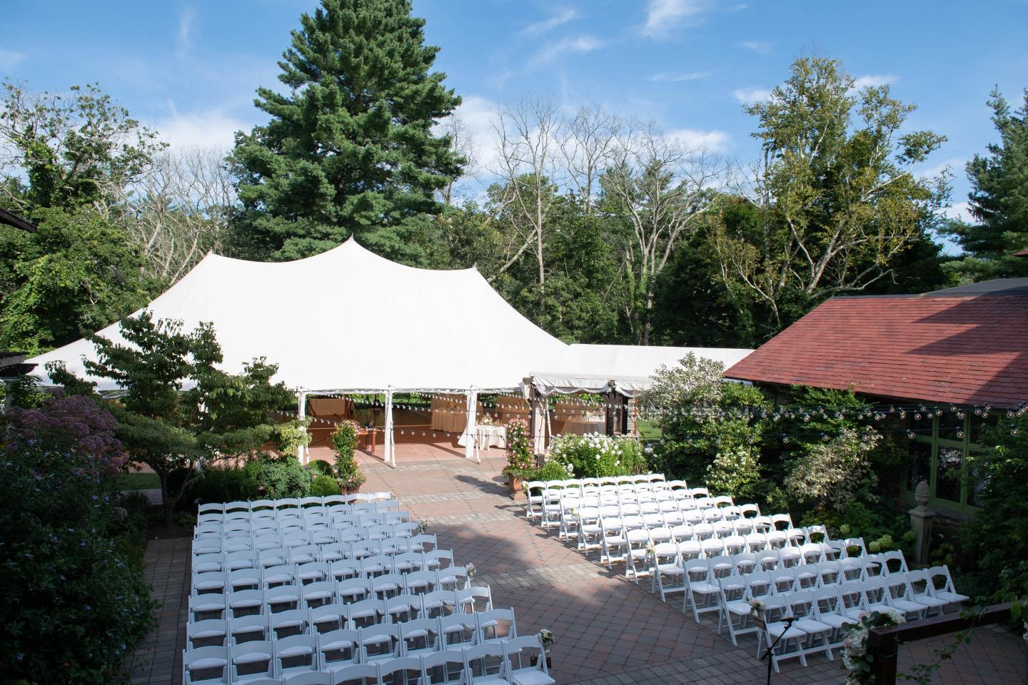 A courtyard and tent set up for a wedding ceremony