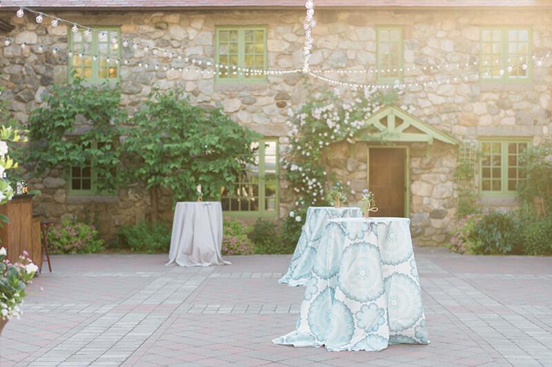 A courtyard set up with standing tables
