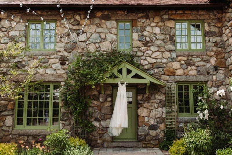 A wedding dress hanging on a doorway