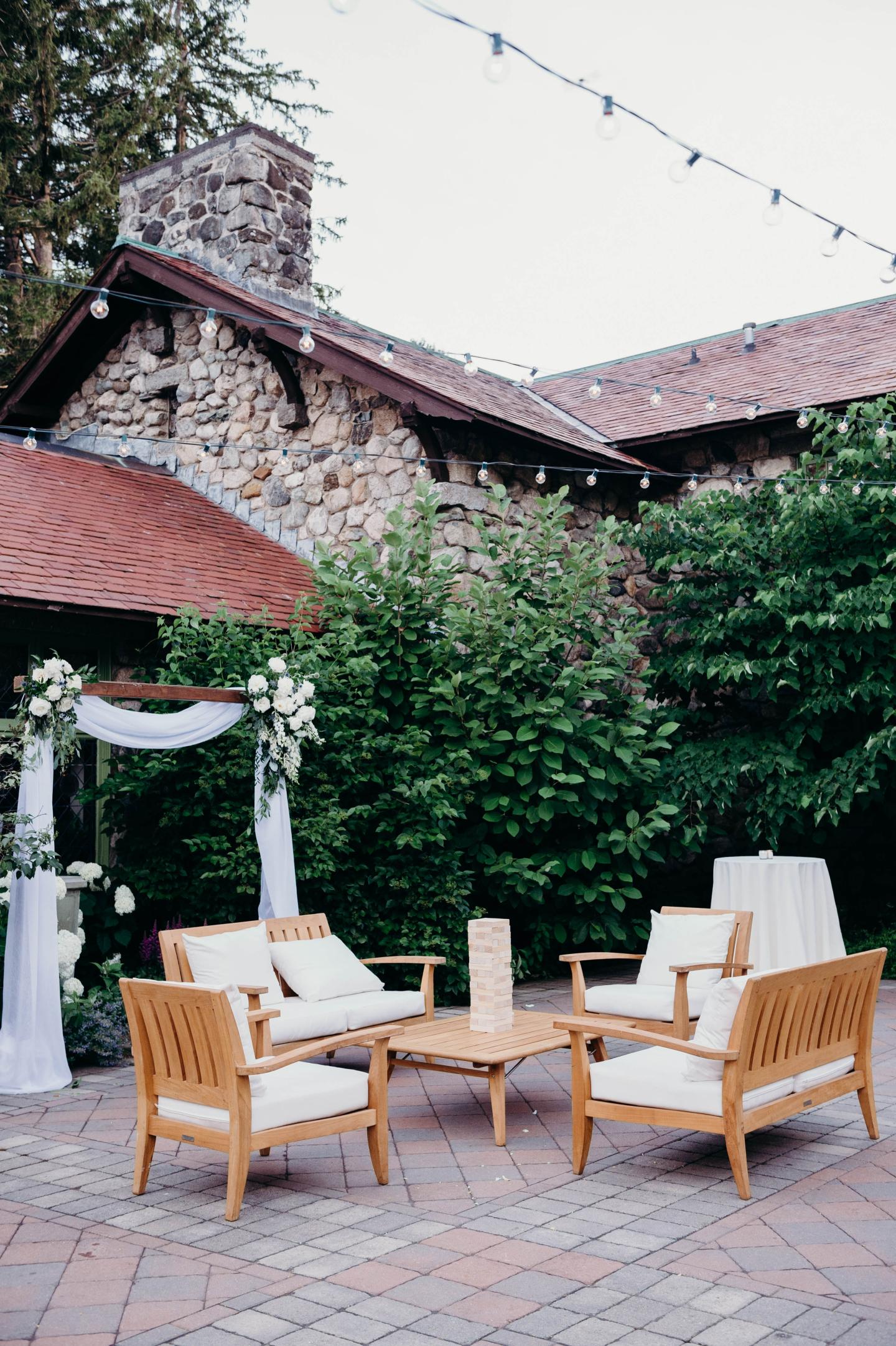 Tables and chairs set up for a wedding in a courtyard