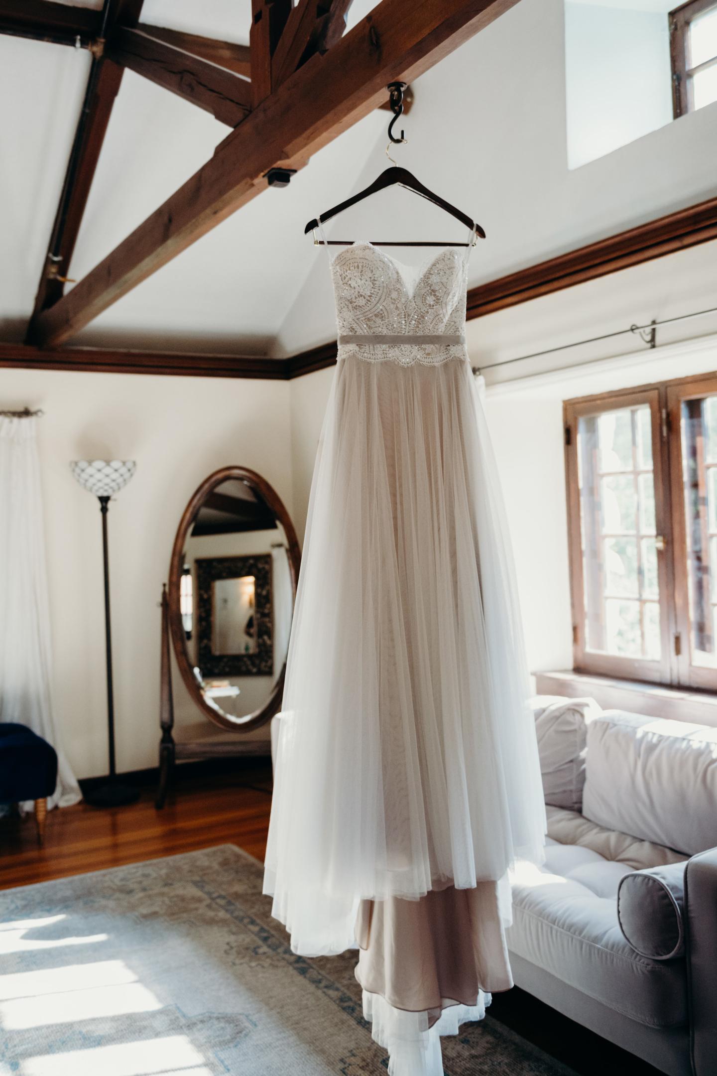 A wedding dress hanging in a suite