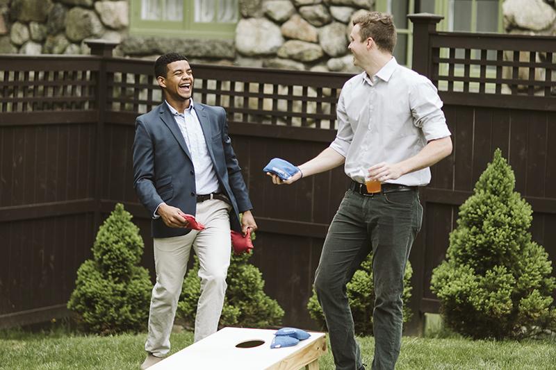 Two people playing bean bag toss
