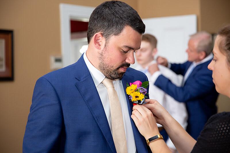 A groom getting dressed for a wedding