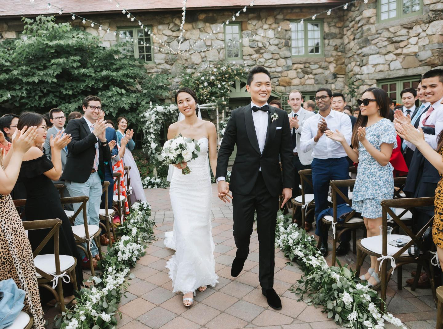 A bride and groom walking down the aisle