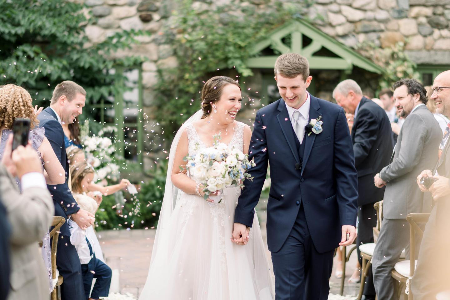A bride and groom walking down the aisle