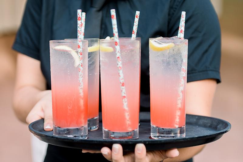 A waiter holding cocktails