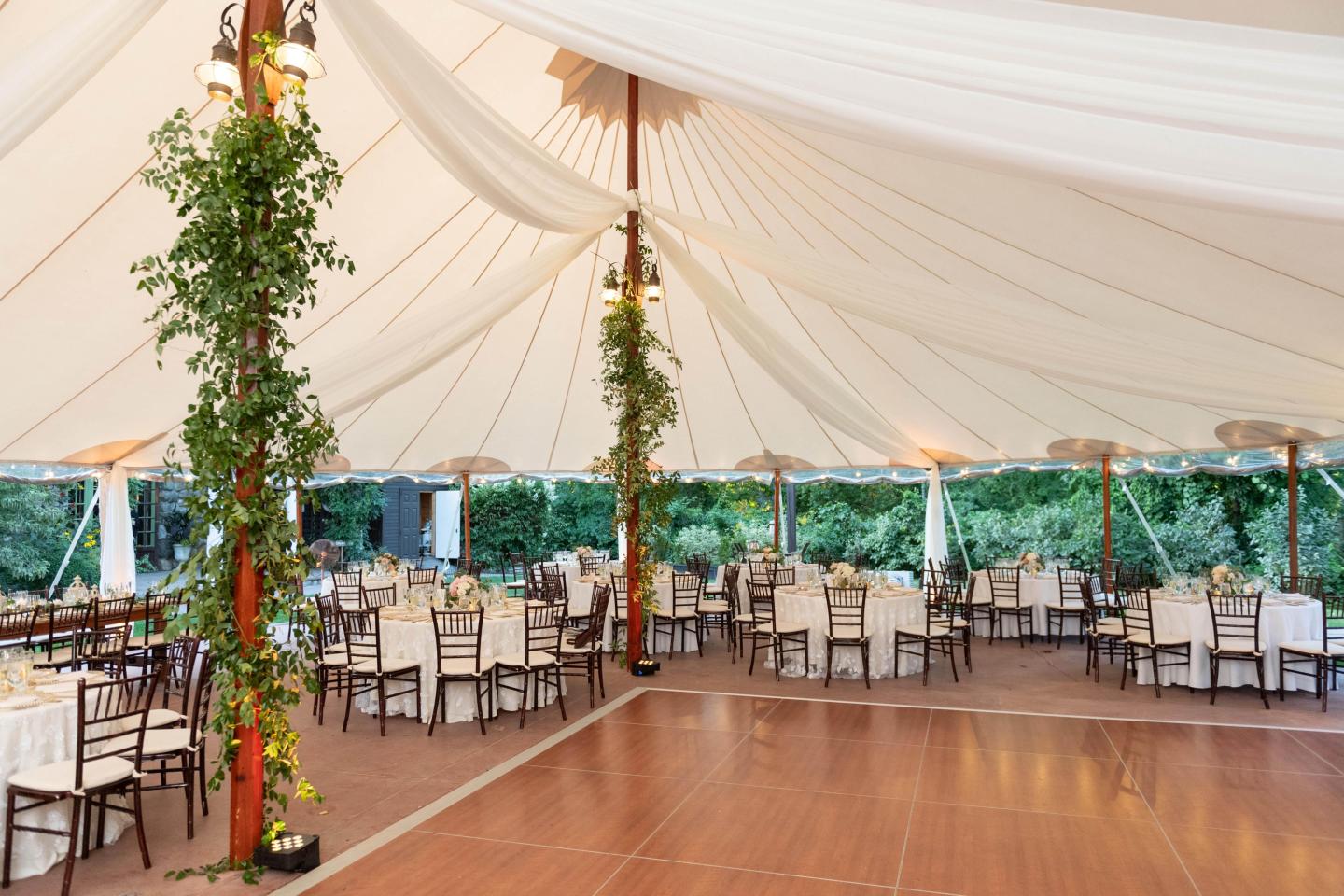 A tent set up for a wedding reception