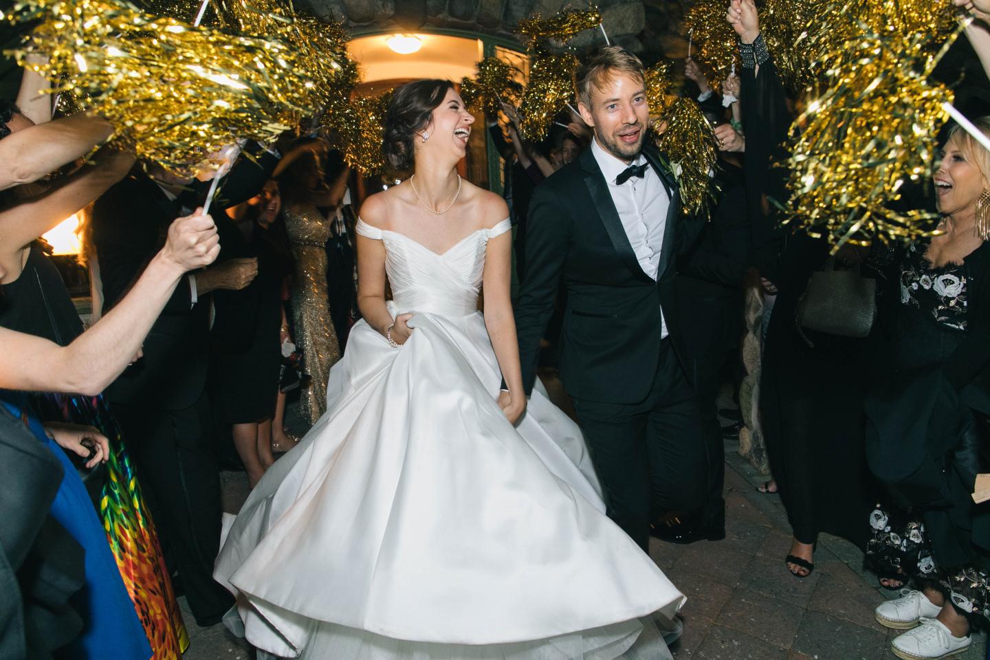 A bride and groom walking down the aisle