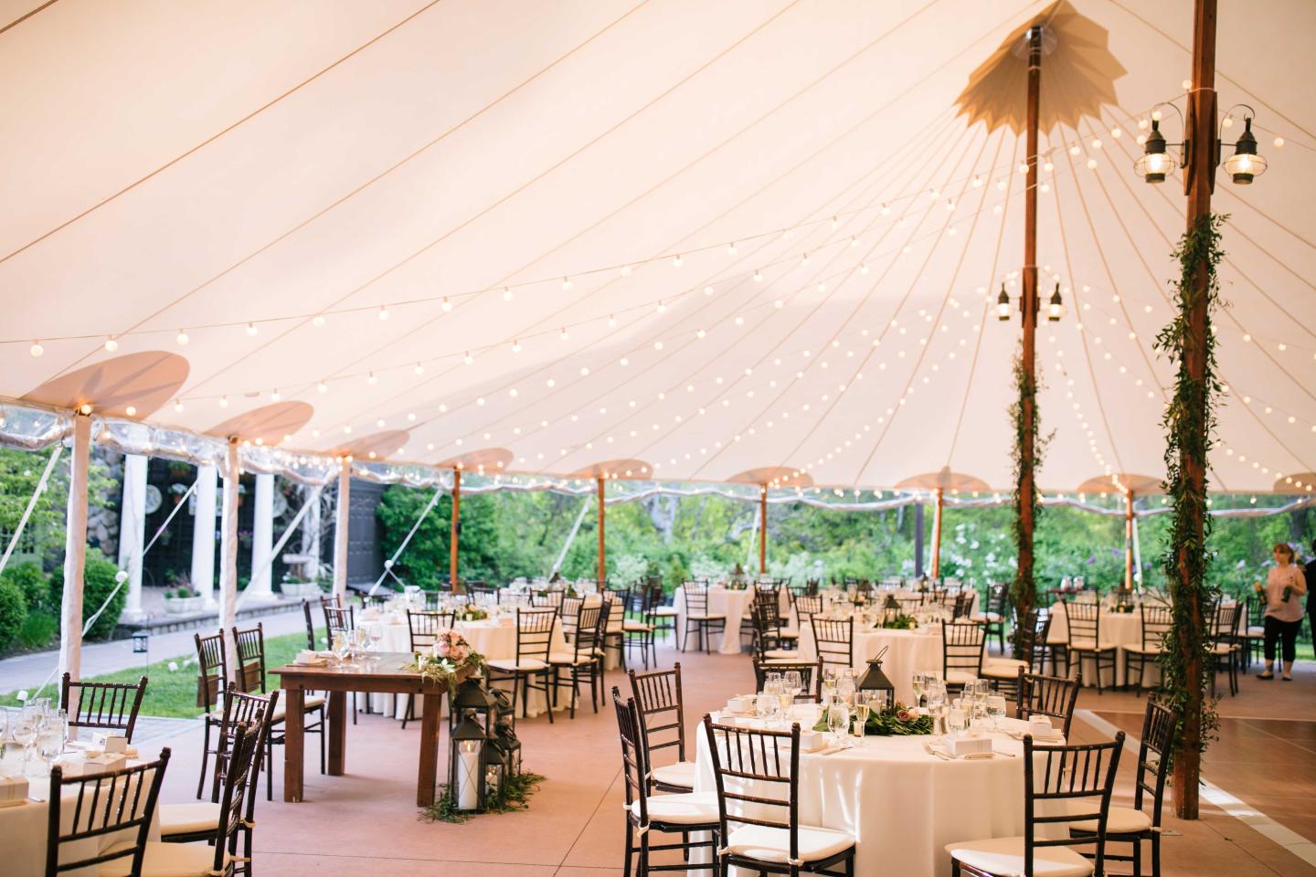 A tent set up for a wedding reception