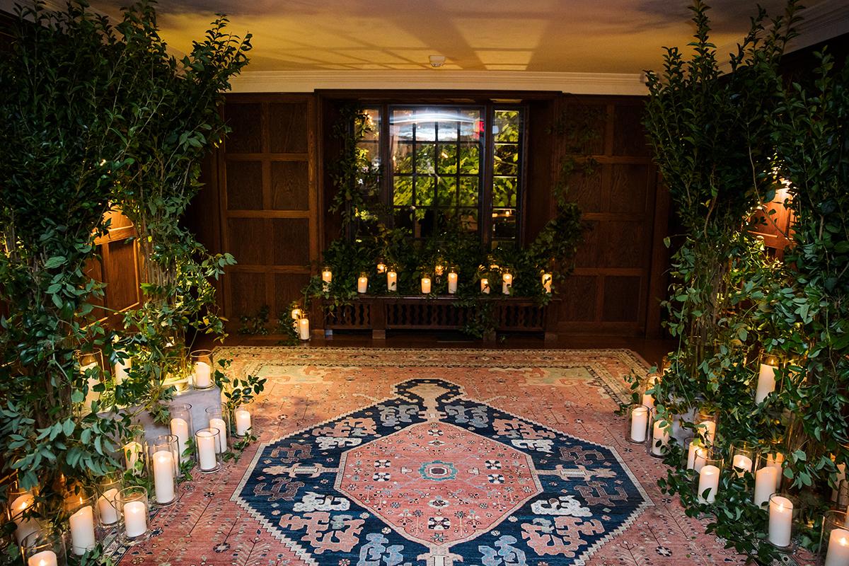 A room decorated with plants and candles
