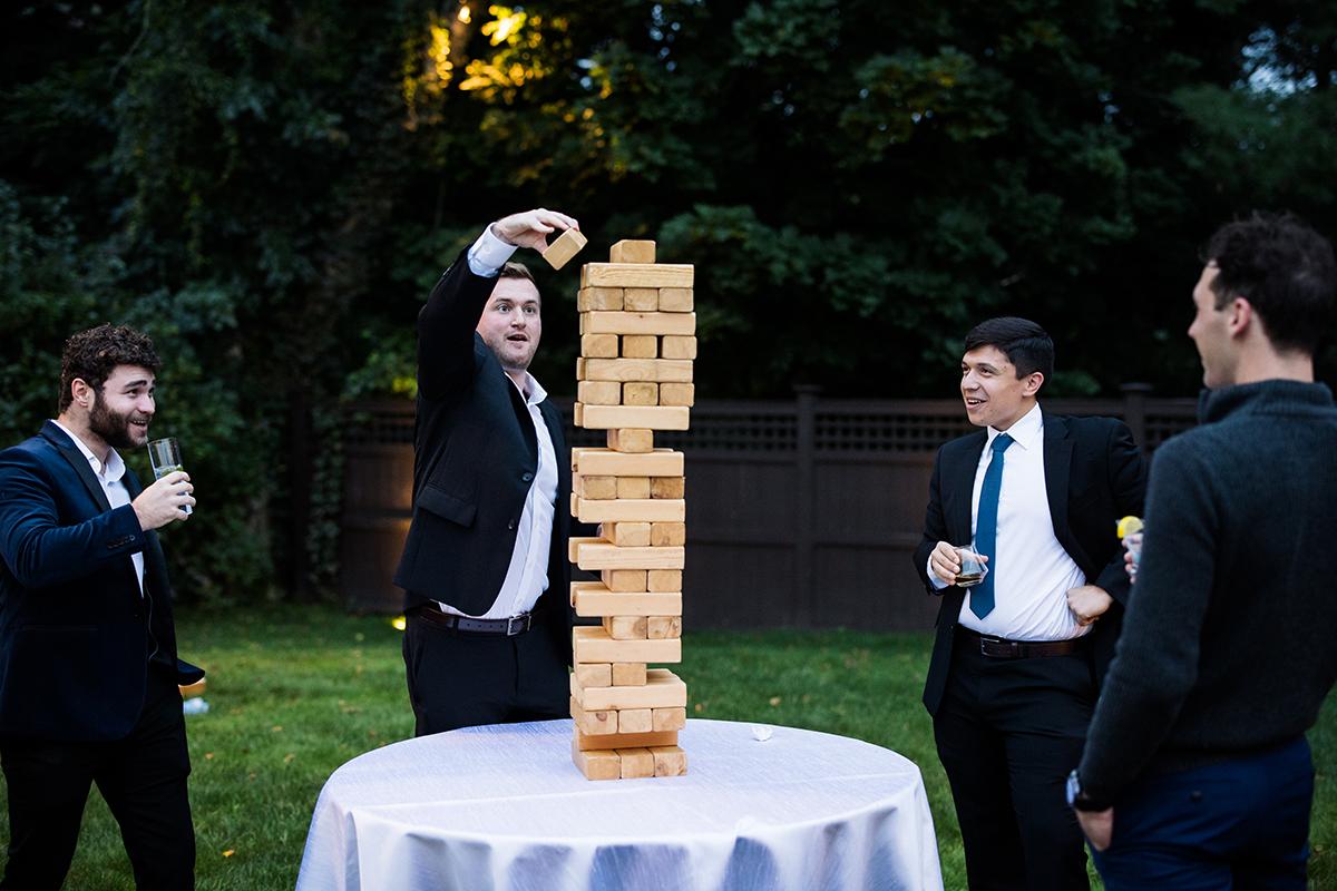 A group of people playing giant jenga