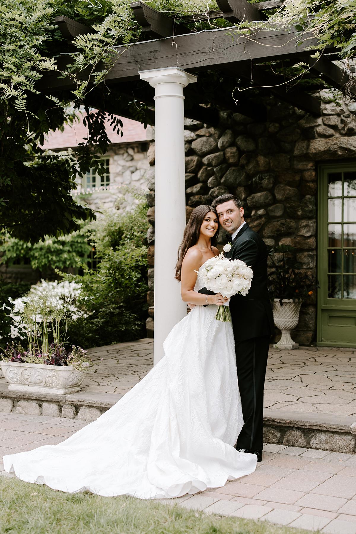 bride and groom by pergola