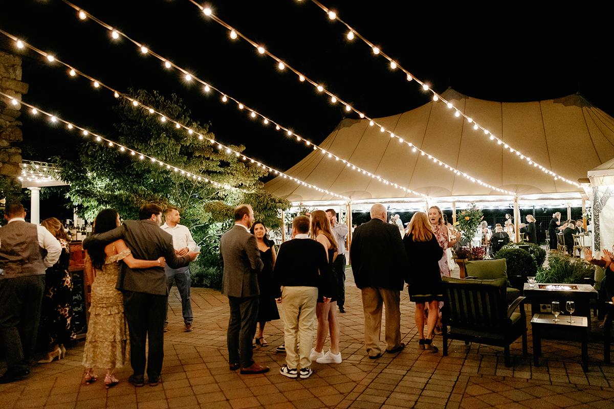 wedding guests in the courtyard with lighting