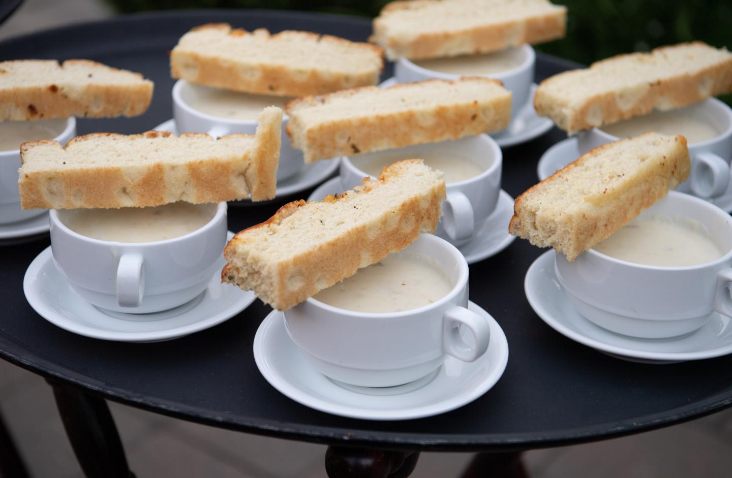 Multiple servings of New England Clam Chowder with bread
