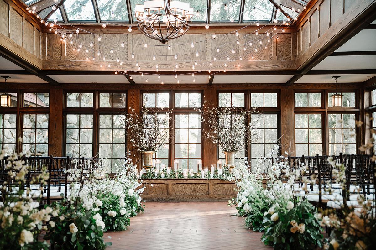 conservatory ceremony with green and white florals