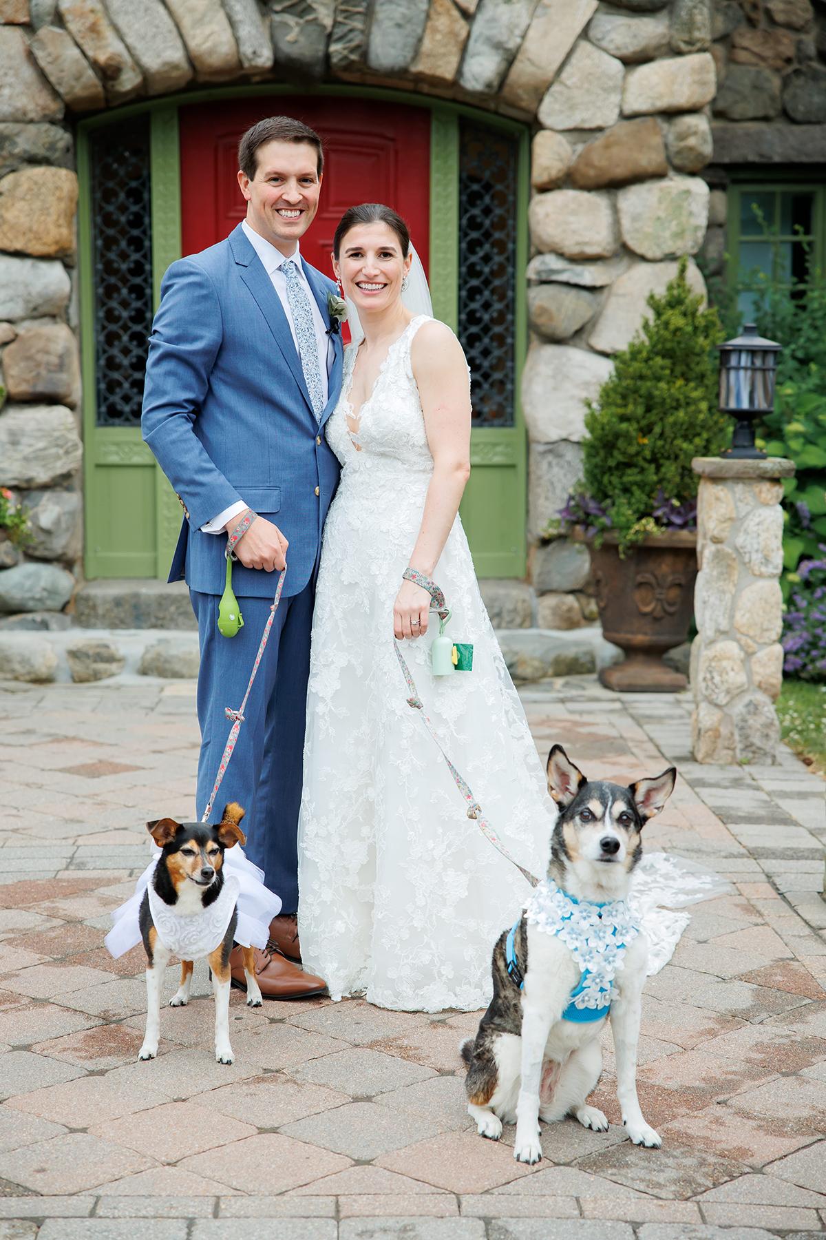 couple by front door with dogs