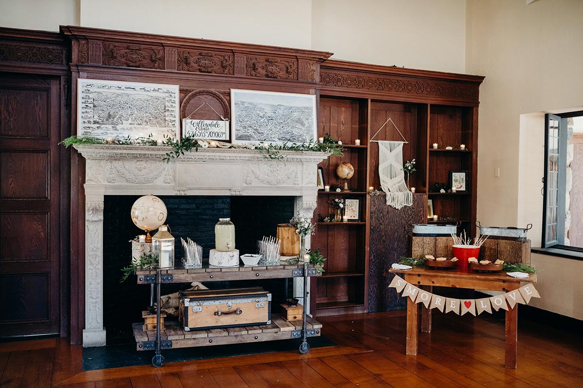 Cozy vintage room with fireplace, globe, and decorative shelves.