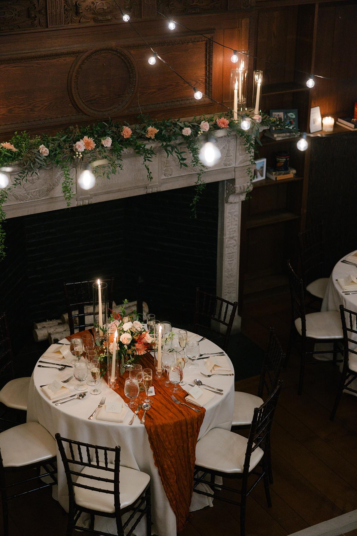 Elegantly set dinner table with candles and floral centerpiece.
