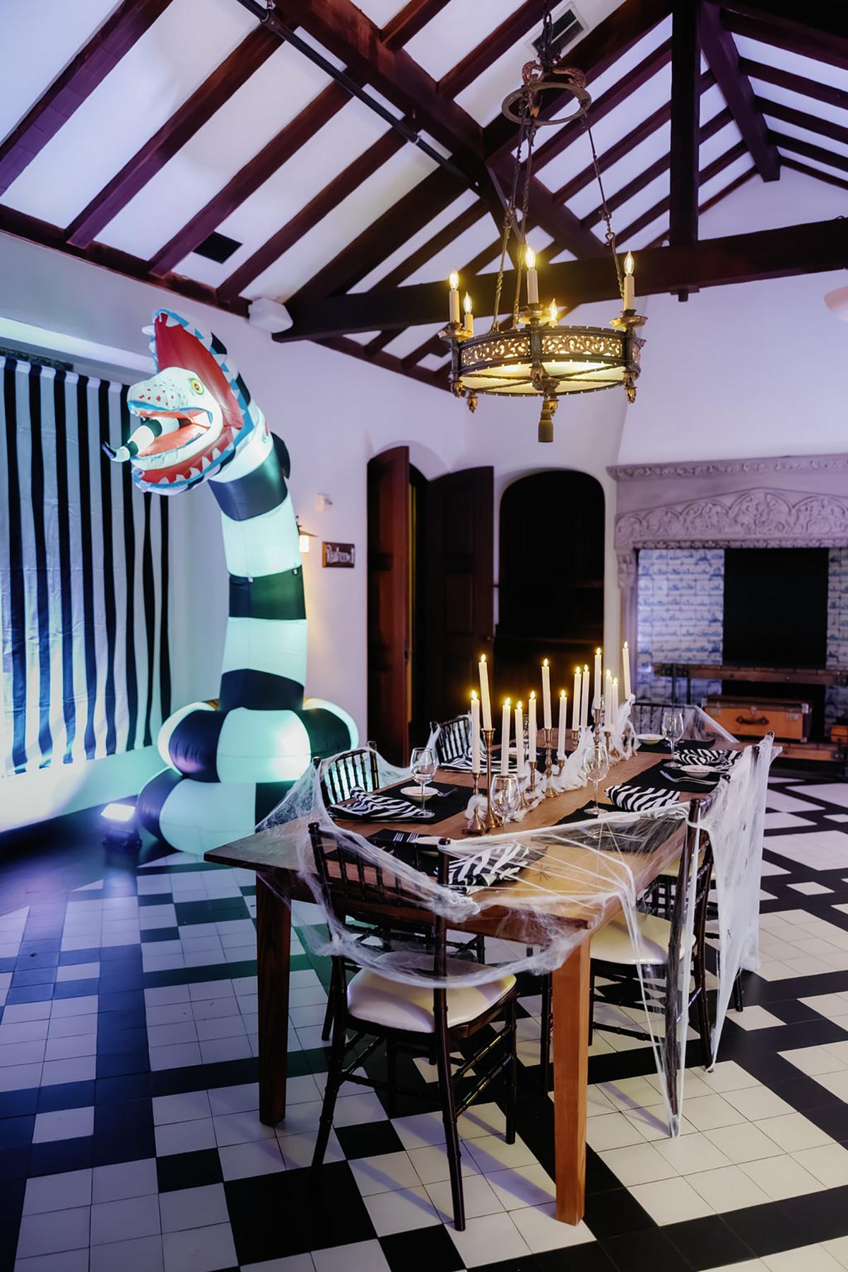 Dining room with Halloween decorations and inflatable striped creature.