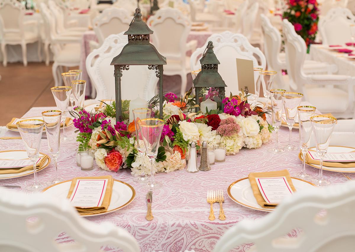 Elegant table setting with floral centerpiece and lanterns.