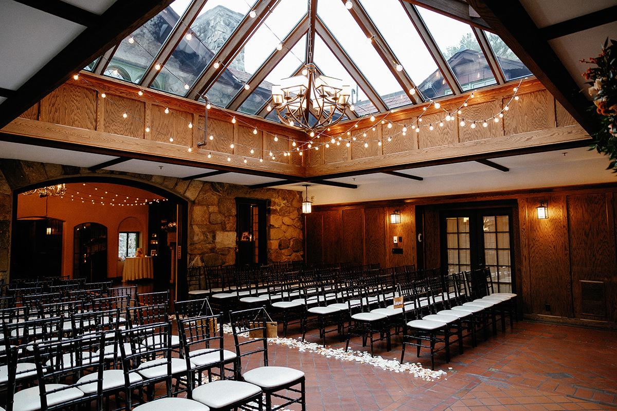 Wedding venue with chairs, skylight, and string lights.