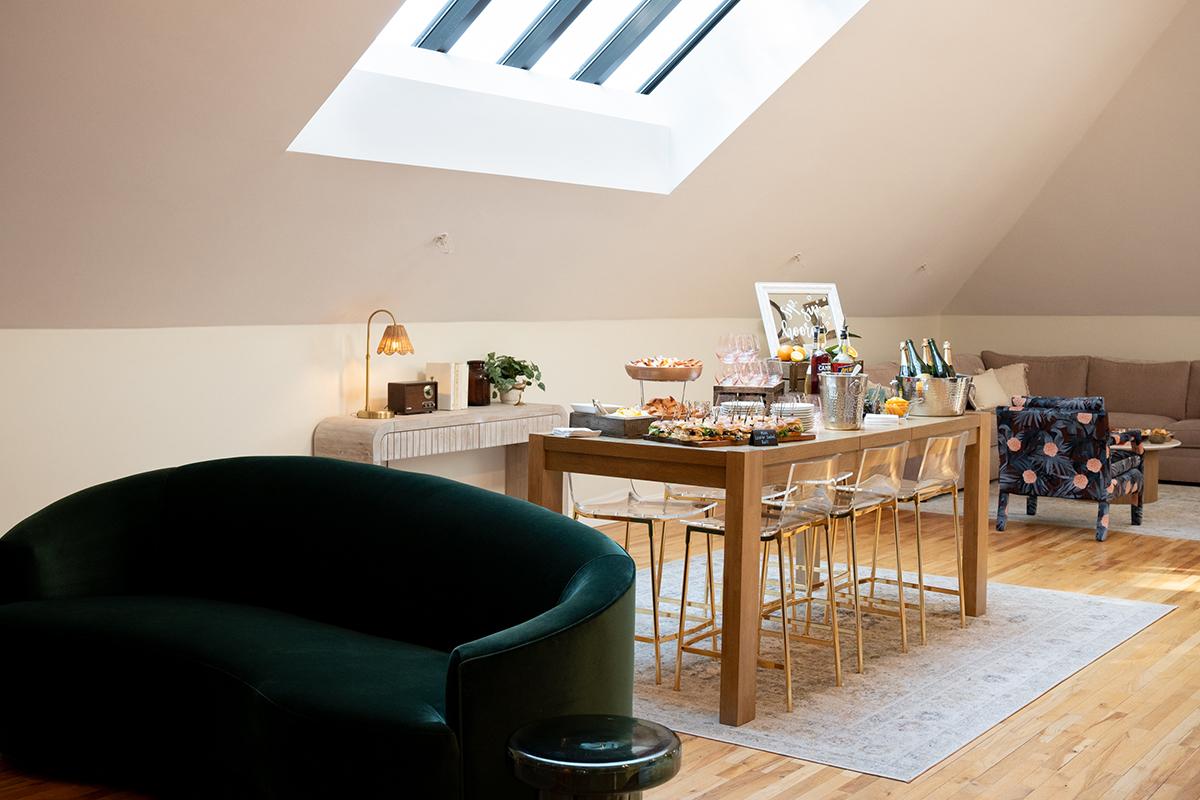 Cozy attic dining room with a skylight and modern furniture.