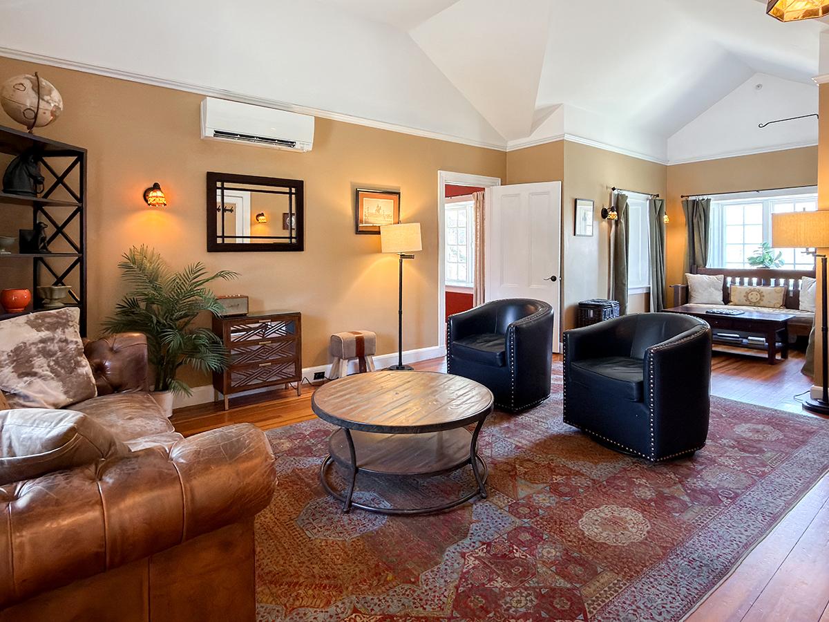 Cozy living room with leather and upholstered seating, warm tones, and natural light.