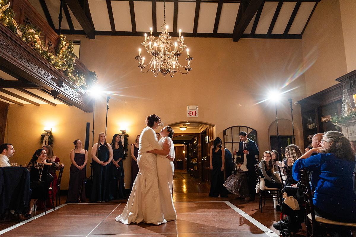 First dance at a wedding in an elegant hall with chandeliers.