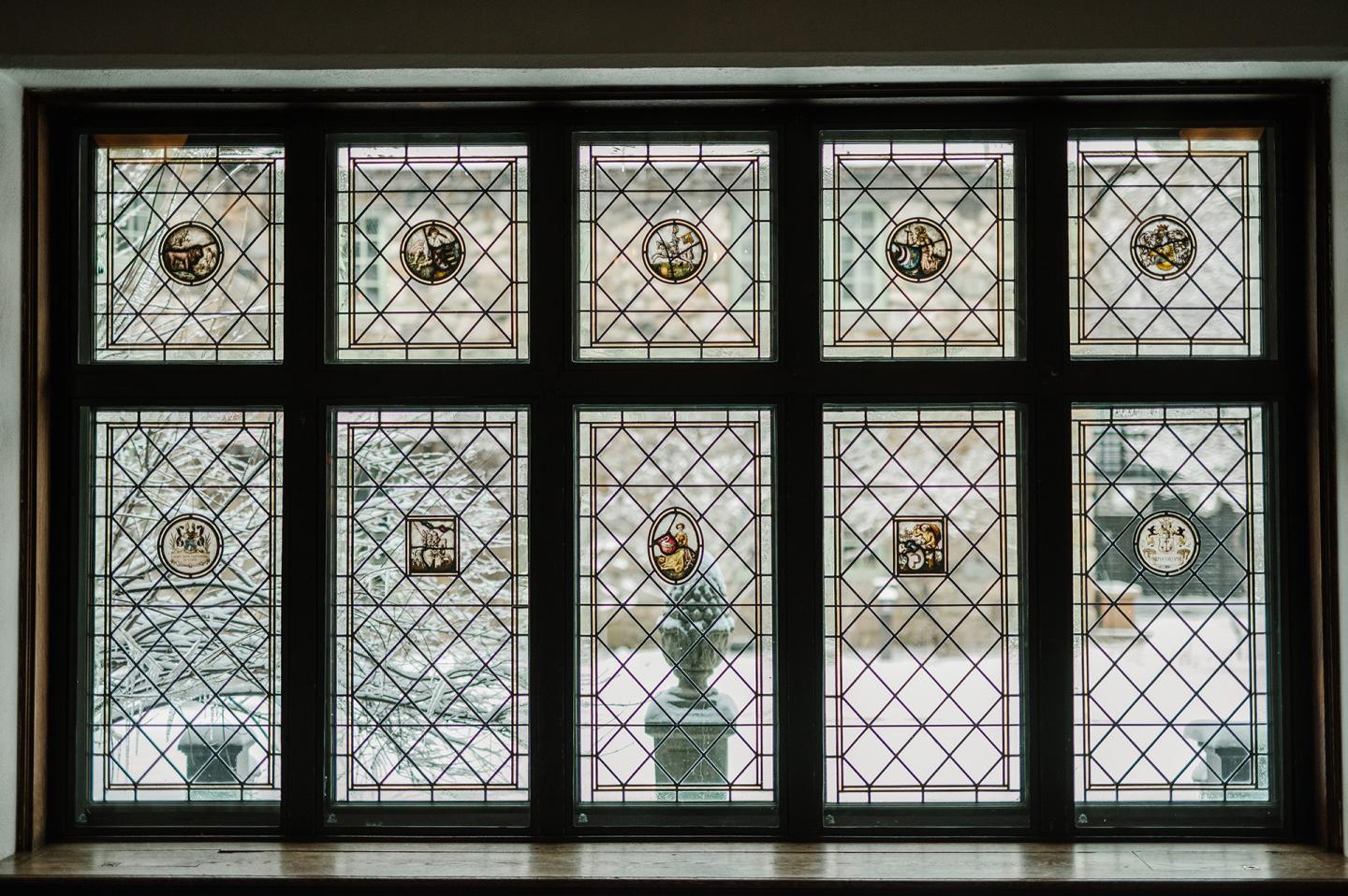 Six stained-glass window panels with geometric patterns and floral medallions.